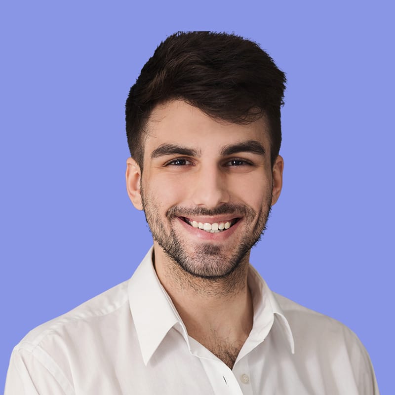 Smiling young man in a white shirt against a light purple background, representing professionalism and customer satisfaction in cleaning services.