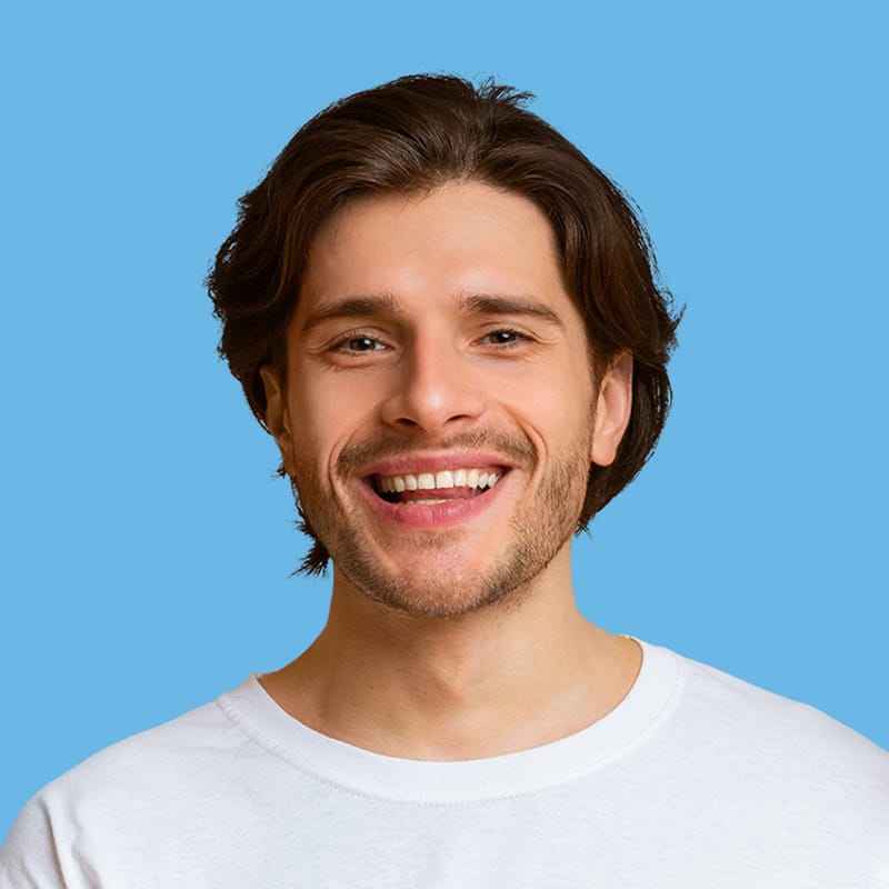 Smiling man in a white t-shirt against a blue background, representing friendly customer service for Exit Cleans, a cleaning service provider.